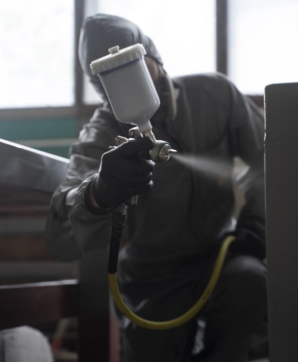 man-spraying-powder-paint-from-gun-front-view